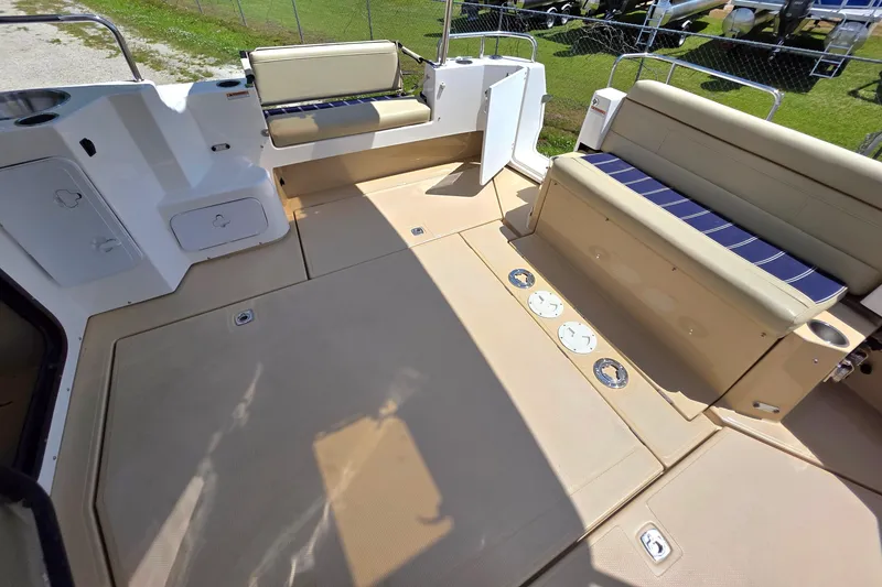 Slide: The Image of Spacious deck of 2020 Ranger Tugs R-31 CB with beige seating and storage compartments. - 9