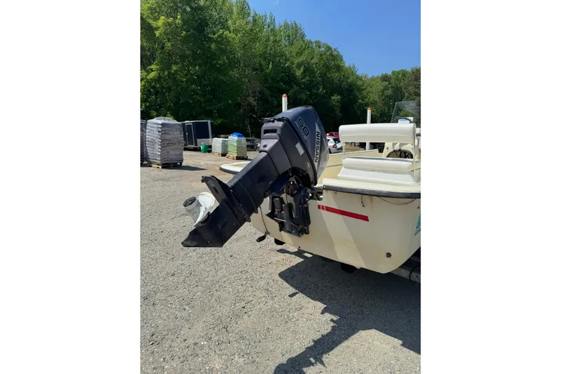 Slide: The Image of 1998 Carolina Skiff Semi-Vee 19 boat with Nissan 50 outboard motor in outdoor setting. - 11
