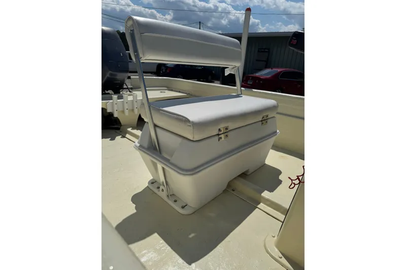 Slide: The Image of 1998 Carolina Skiff Semi-Vee 19 boat seat with storage, under sunny sky. - 8
