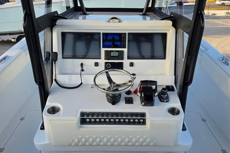 Slide: The Image of Helm of 2026 Invincible 33 Catamaran with advanced navigation and control systems. - 11