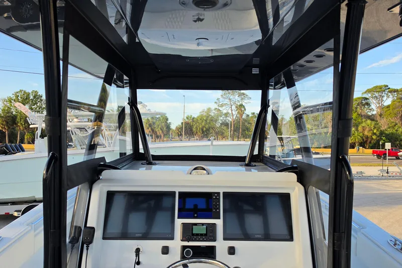 Slide: The Image of Interior view of 2026 Invincible 33 Catamaran cockpit with modern navigation equipment. - 12