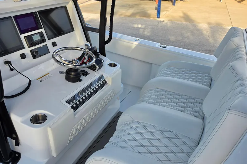 Slide: The Image of 2026 Invincible 33 Catamaran cockpit with modern controls and luxurious seating. - 13