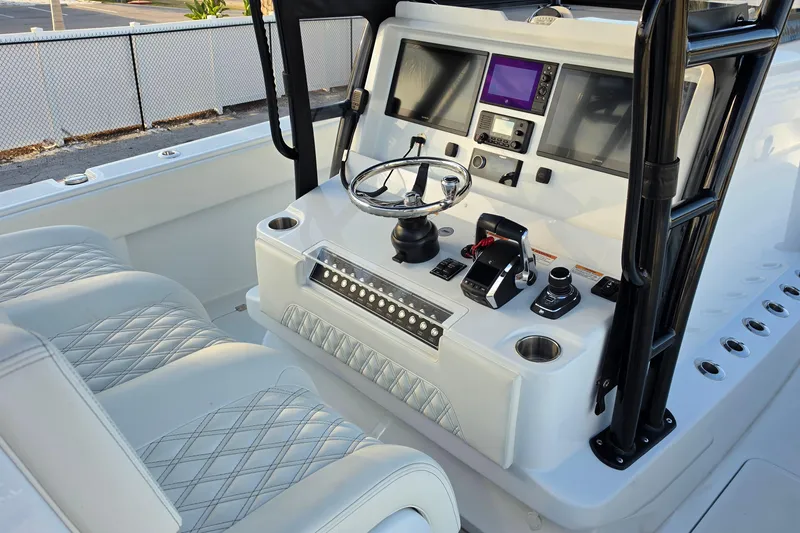 Slide: The Image of Helm of 2026 Invincible 33 Catamaran with modern controls and plush seating. - 14