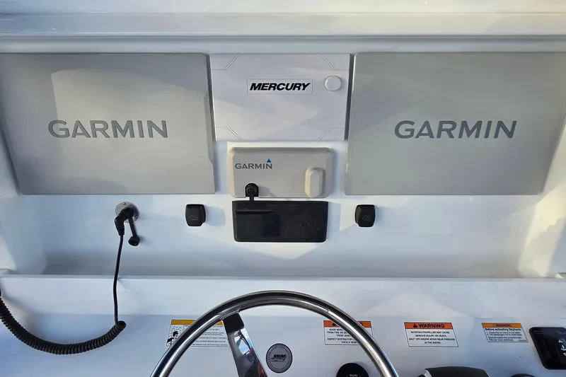 Slide: The Image of Control panel of 2026 Invincible 33 Catamaran featuring Garmin and Mercury systems. - 17