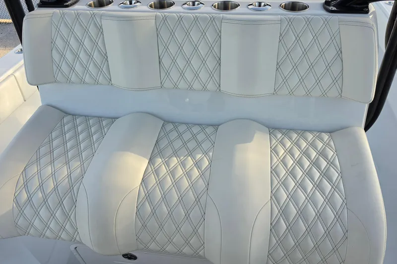 Slide: The Image of Luxurious seating on 2026 Invincible 33 Catamaran with diamond-stitched upholstery and cup holders. - 18