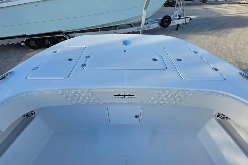 Slide: The Image of 2026 Invincible 33 Catamaran deck view with storage compartments and sleek design. - 19