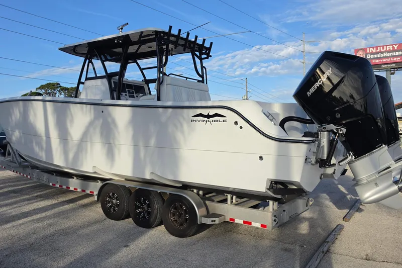 Slide: The Image of 2026 Invincible 33 Catamaran on trailer with Mercury outboard motor. - 3