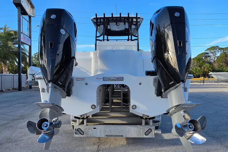 Slide: The Image of 2026 Invincible 33 Catamaran with dual outboard engines, rear view. - 4