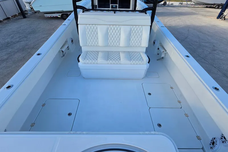 Slide: The Image of 2026 Invincible 33 Catamaran interior with white seating and spacious deck layout. - 8