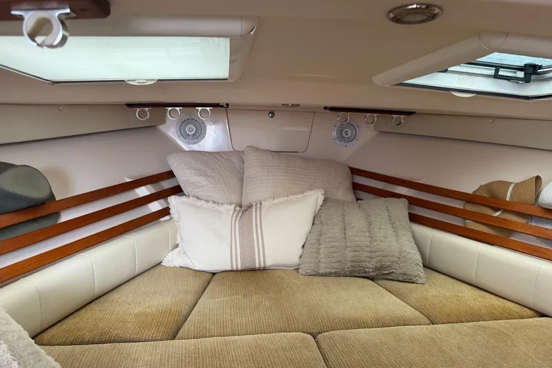 Slide: The Image of Cozy cabin interior of 2007 Grady-White Express 330 with cushions and wooden accents. - 12