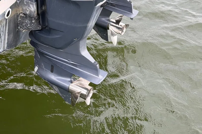 Slide: The Image of Twin outboard motors on a 2007 Grady-White Express 330 boat in water. - 14