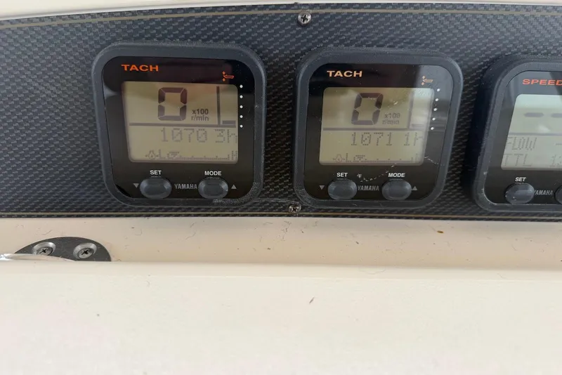 Slide: The Image of Dashboard of a 2007 Grady-White Express 330 boat with Yamaha tachometers. - 16