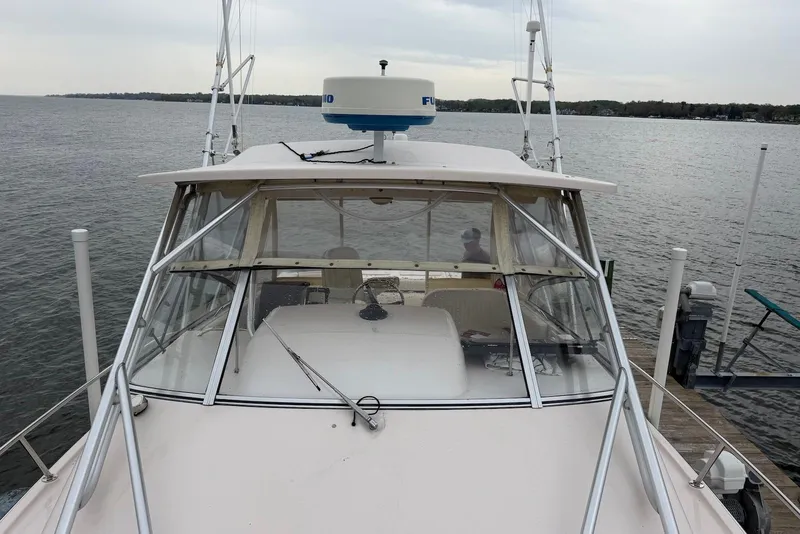 Slide: The Image of 2007 Grady-White Express 330 boat docked on a calm lake. - 2