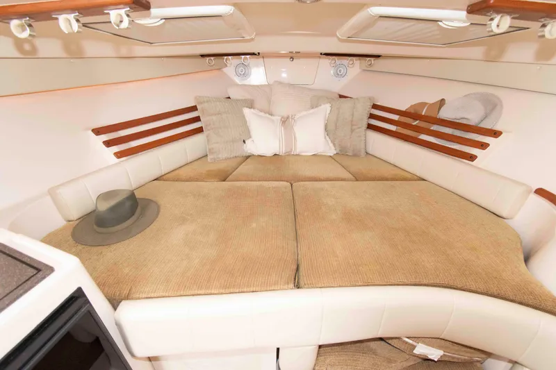 Slide: The Image of 2007 Grady-White Express 330 cabin interior with cozy bedding and stylish decor. - 20