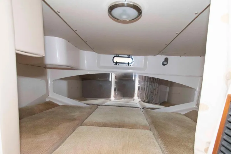 Slide: The Image of 2007 Grady-White Express 330 cabin interior with cozy sleeping area and porthole window. - 23