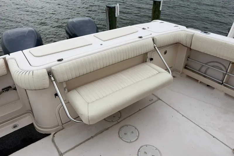 Slide: The Image of 2007 Grady-White Express 330 boat with foldable seating and twin engines by the water. - 4