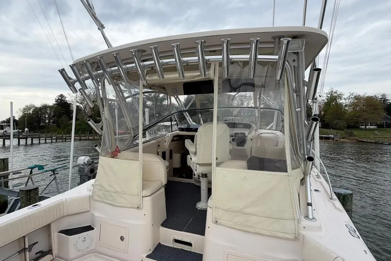 Slide: The Image of 2007 Grady-White Express 330 boat docked, featuring a spacious cockpit and rod holders. - 5