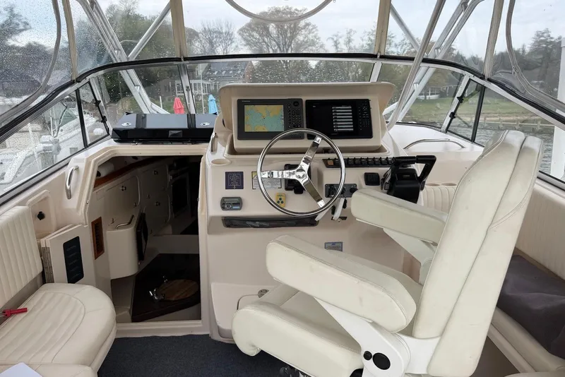 Slide: The Image of 2007 Grady-White Express 330 boat cockpit with steering wheel and navigation equipment. - 6