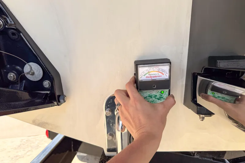 Slide: The Image of Hand using moisture meter on 2007 Fountain 42 Lightning boat hull. - 21