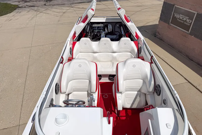 Slide: The Image of 2007 Fountain 42 Lightning boat interior with white and red seating, parked on concrete. - 31