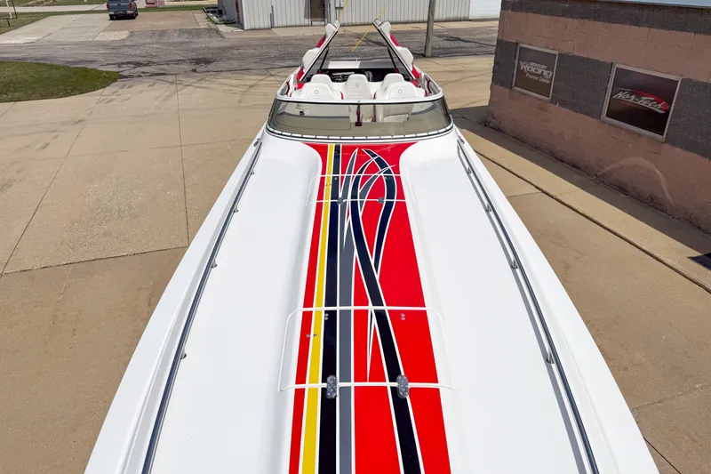 Slide: The Image of 2007 Fountain 42 Lightning boat with vibrant red, yellow, and black stripes on deck. - 33