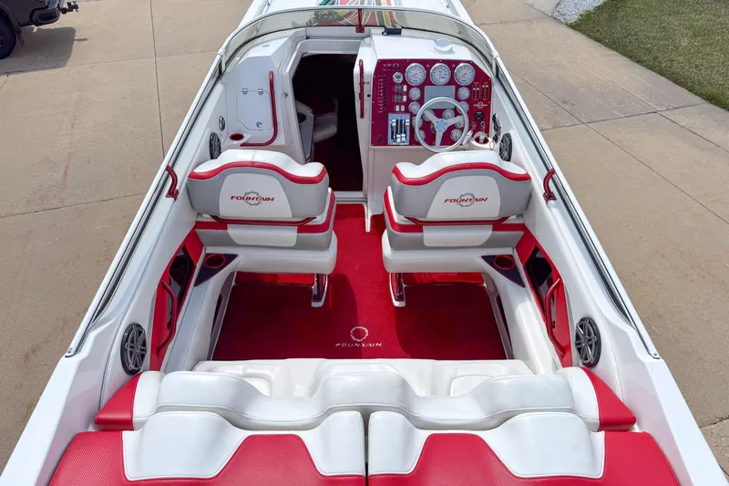 Slide: The Image of 2007 Fountain 42 Lightning boat interior with red and white seating and dashboard. - 38