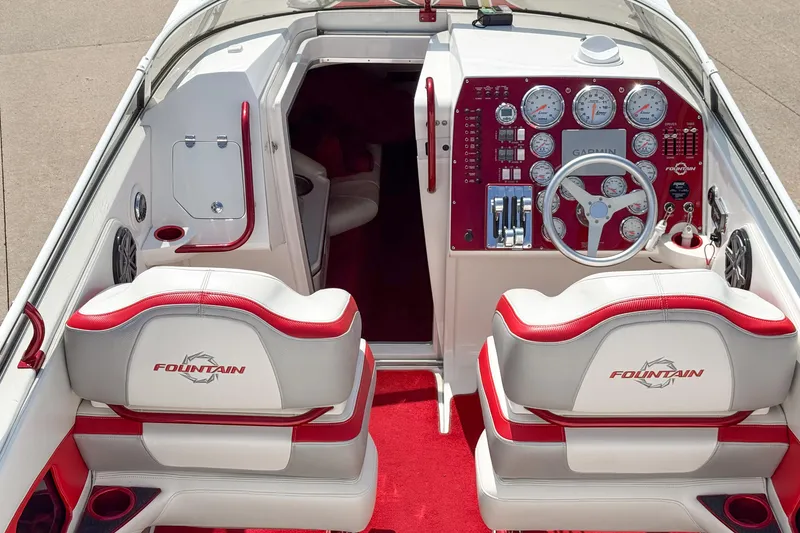 Slide: The Image of 2007 Fountain 42 Lightning boat interior with red and white seating, dashboard, and steering wheel. - 39