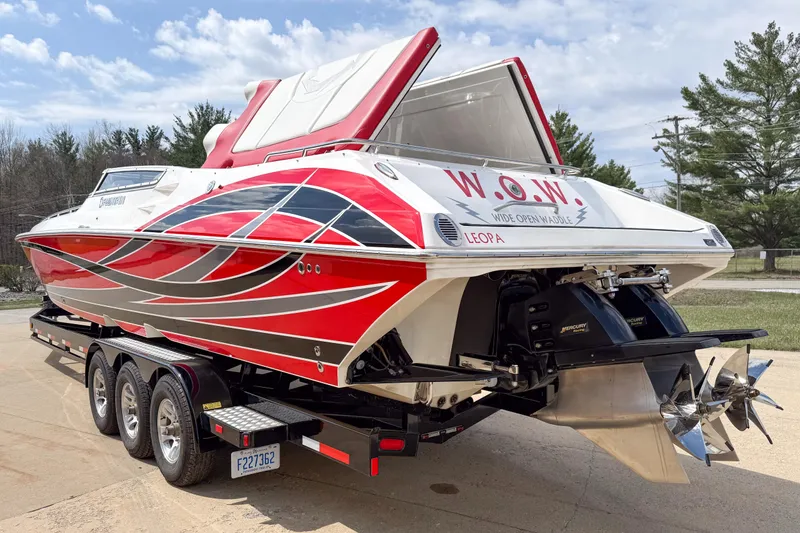 Slide: The Image of 2007 Fountain 42 Lightning speedboat with vibrant red and silver design on a trailer. - 4