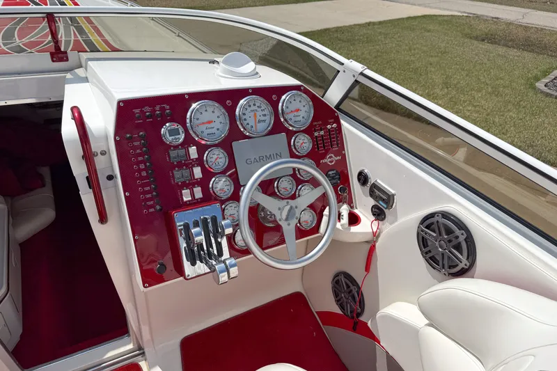 Slide: The Image of 2007 Fountain 42 Lightning boat dashboard with red accents and Garmin navigation system. - 40