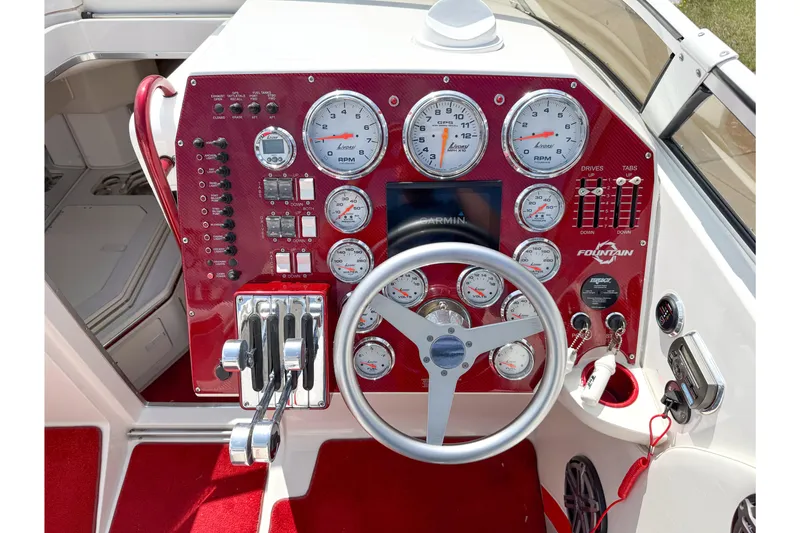 Slide: The Image of 2007 Fountain 42 Lightning boat dashboard with red panel and multiple gauges. - 41