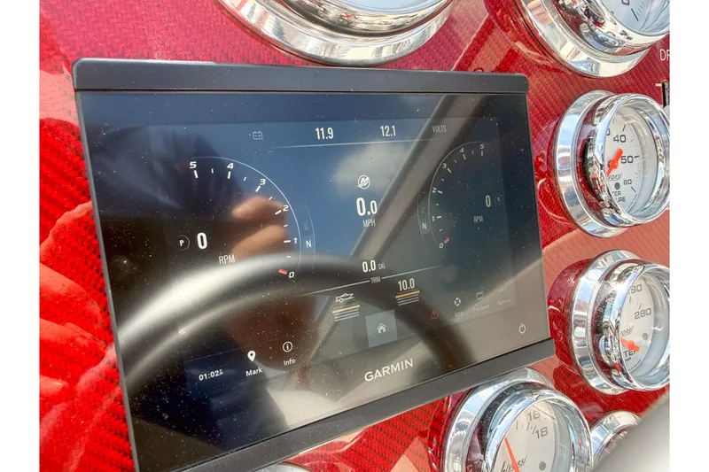 Slide: The Image of Dashboard of a 2007 Fountain 42 Lightning boat with Garmin display and gauges. - 42