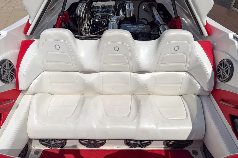 Slide: The Image of 2007 Fountain 42 Lightning boat interior with white leather seats and visible engine. - 48