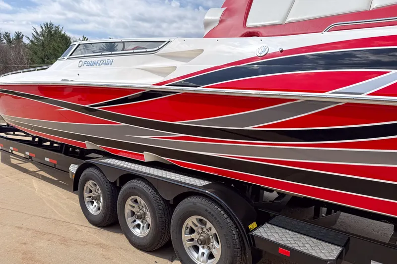 Slide: The Image of 2007 Fountain 42 Lightning speedboat with vibrant red and black design on a trailer. - 5