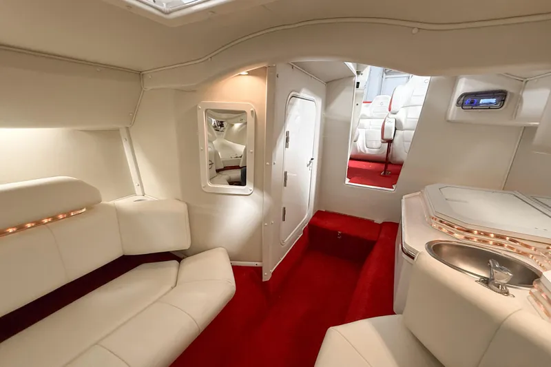Slide: The Image of Luxurious interior of a 2007 Fountain 42 Lightning boat with white seating and red carpet. - 55