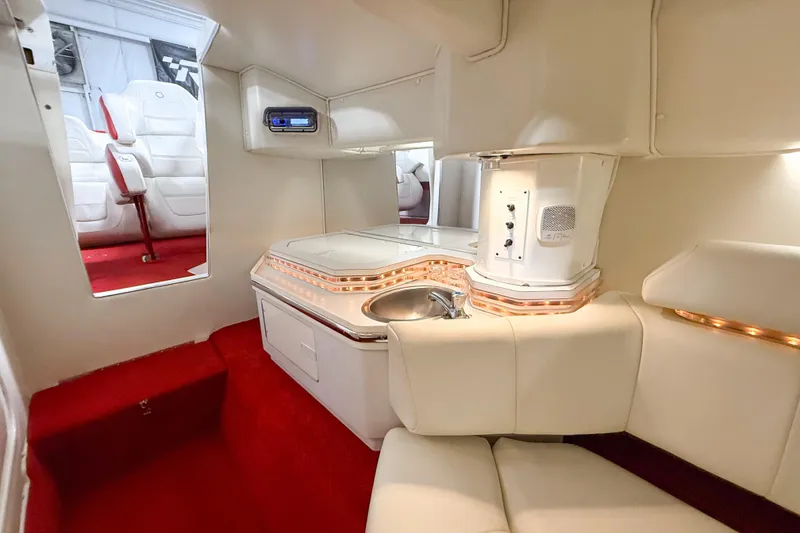 Slide: The Image of Luxurious interior of a 2007 Fountain 42 Lightning boat with white seating and red carpet. - 57