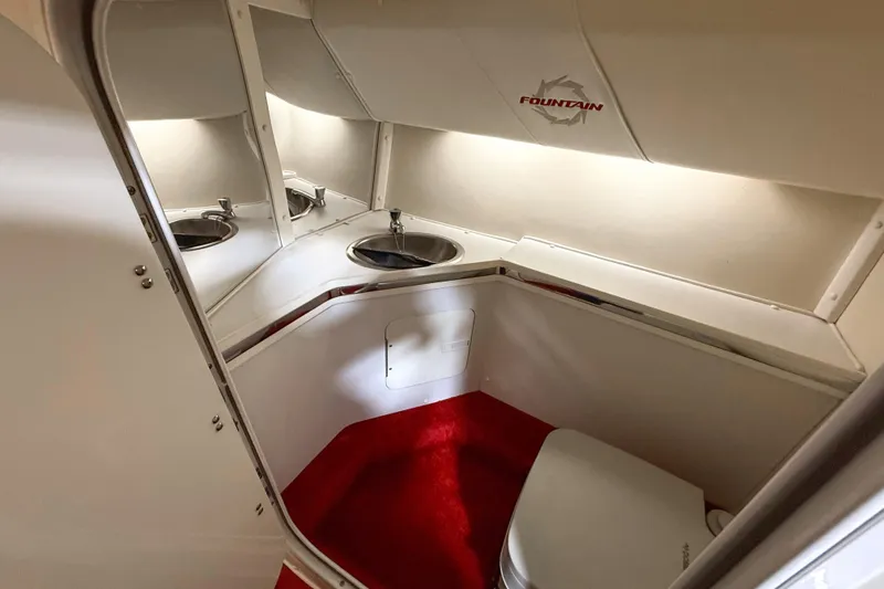 Slide: The Image of Interior of 2007 Fountain 42 Lightning boat bathroom with sink and red carpet. - 58
