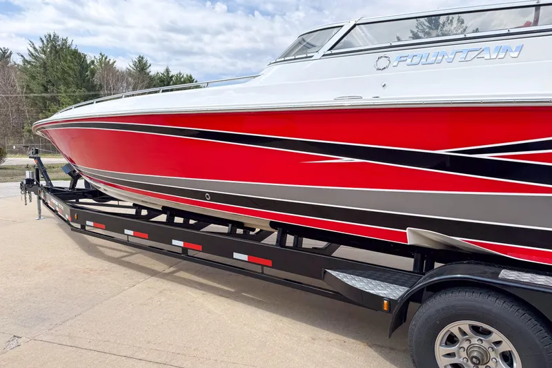Slide: The Image of 2007 Fountain 42 Lightning speedboat on trailer, featuring sleek red and black design. - 6