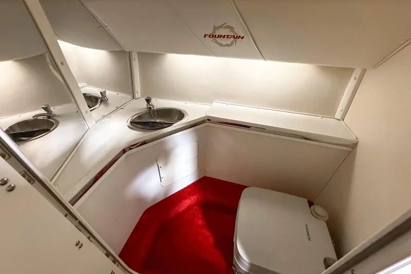 Slide: The Image of 2007 Fountain 42 Lightning boat interior with sink and red carpeted floor. - 60