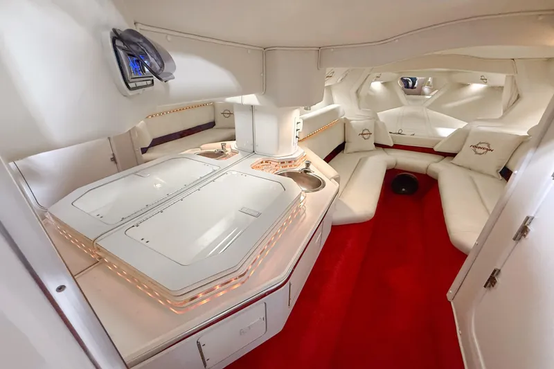 Slide: The Image of Luxurious interior of a 2007 Fountain 42 Lightning boat with white seating and red carpet. - 62