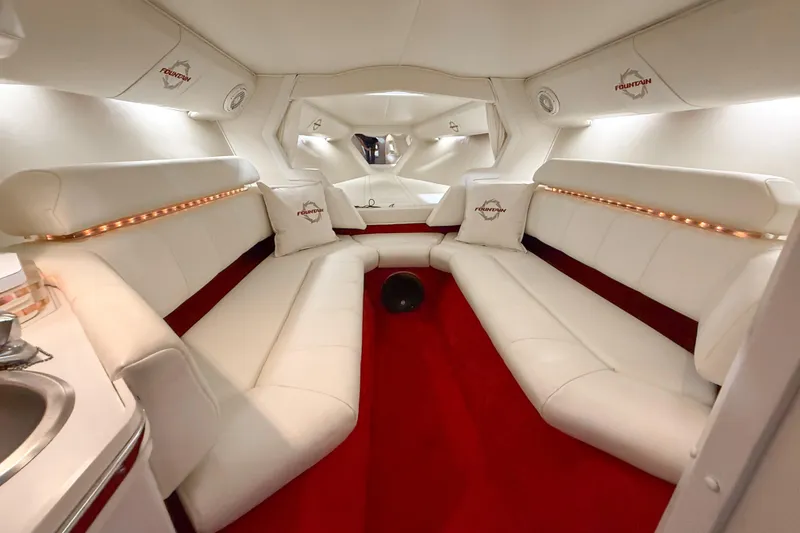 Slide: The Image of Luxurious interior of a 2007 Fountain 42 Lightning boat with white seating and red carpet. - 64