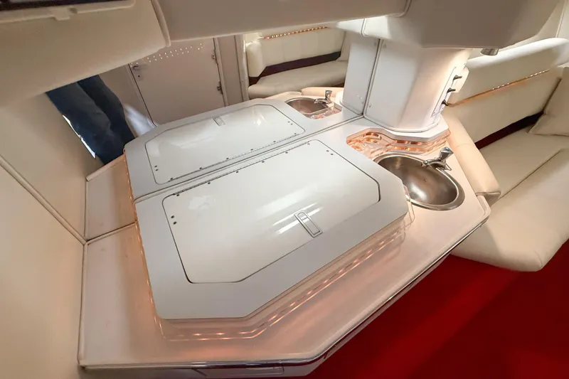 Slide: The Image of Interior of a 2007 Fountain 42 Lightning boat with sleek white cabinetry and sink. - 66