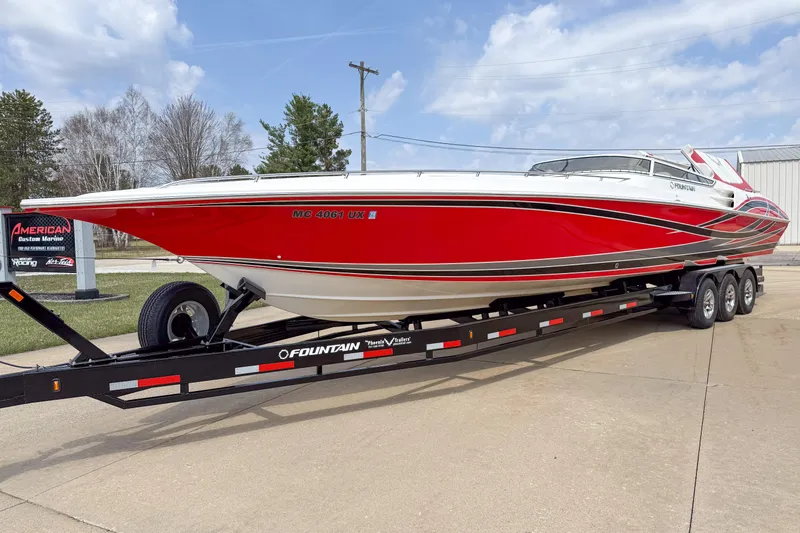 Slide: The Image of 2007 Fountain 42 Lightning speedboat in vibrant red on a trailer, parked outdoors. - 8