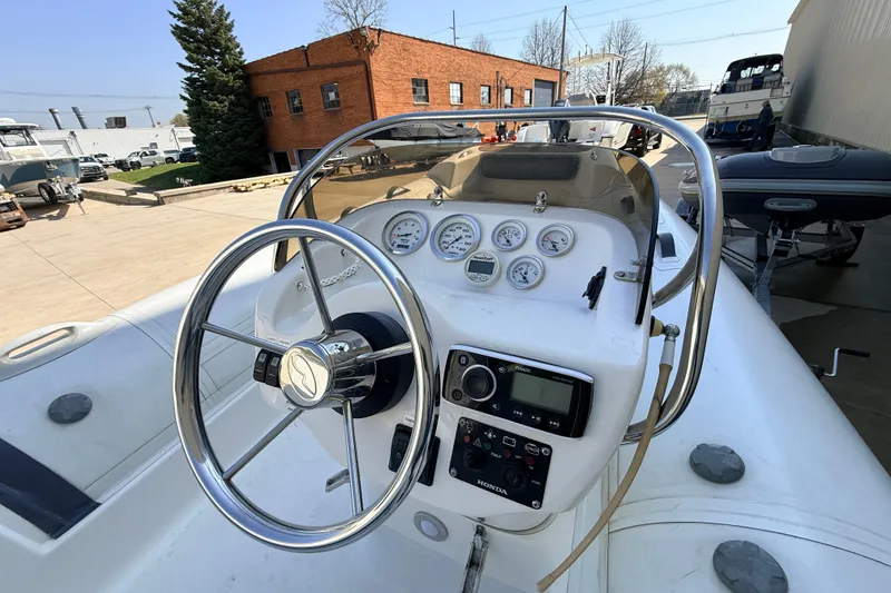 Slide: The Image of Steering console of a 2015 Walker Bay 450 Generation boat with gauges and controls. - 10