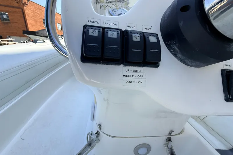 Slide: The Image of Control panel of 2015 Walker Bay 450 Generation boat with labeled switches. - 12
