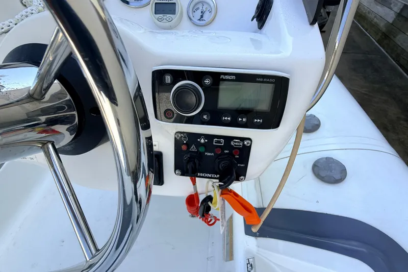 Slide: The Image of Steering console of 2015 Walker Bay 450 Generation boat with controls and gauges. - 13