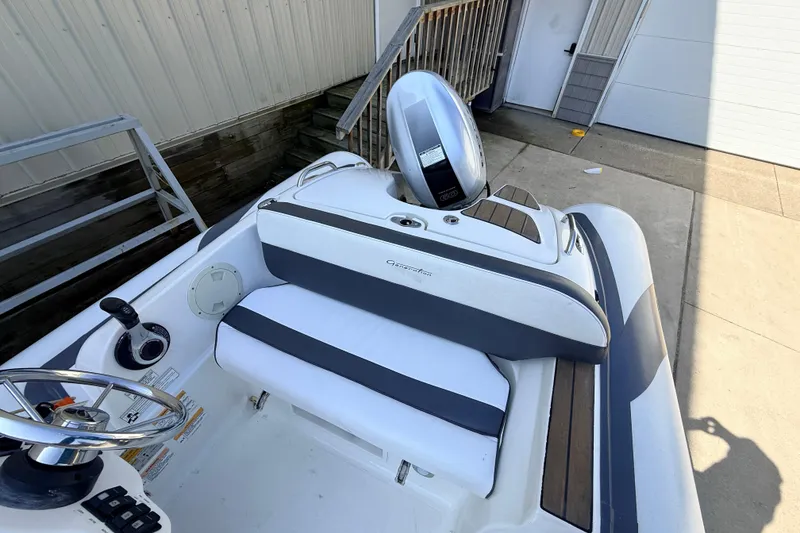 Slide: The Image of 2015 Walker Bay 450 Generation boat interior with steering wheel and seating. - 14