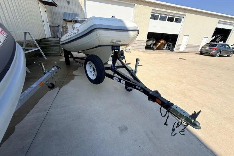 Slide: The Image of 2015 Walker Bay 450 Generation boat on trailer outside a garage. - 15