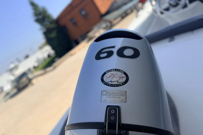 Slide: The Image of Outboard motor on 2015 Walker Bay 450 Generation boat, featuring ultra-low emission technology. - 6