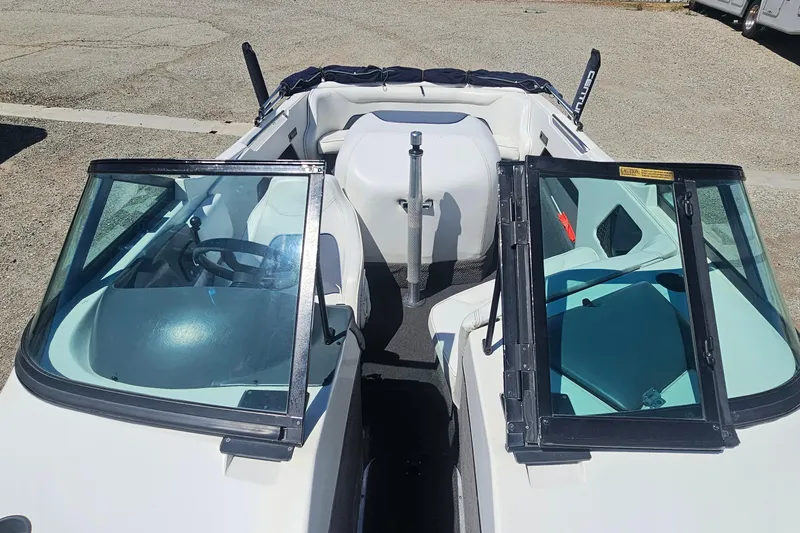 Slide: The Image of 2000 Centurion Sport Bowrider boat interior with open windshield and seating. - 10