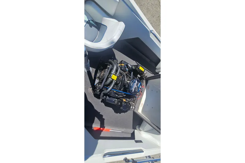Slide: The Image of Engine compartment of a 2000 Centurion Sport Bowrider boat, showcasing the motor. - 12
